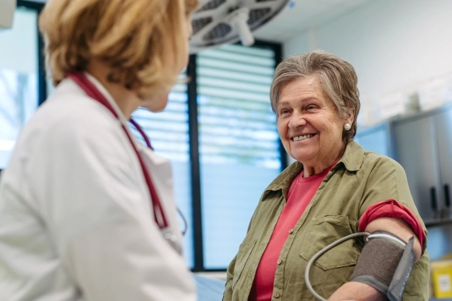 Patient receiving a blood pressure check during a medical appointment